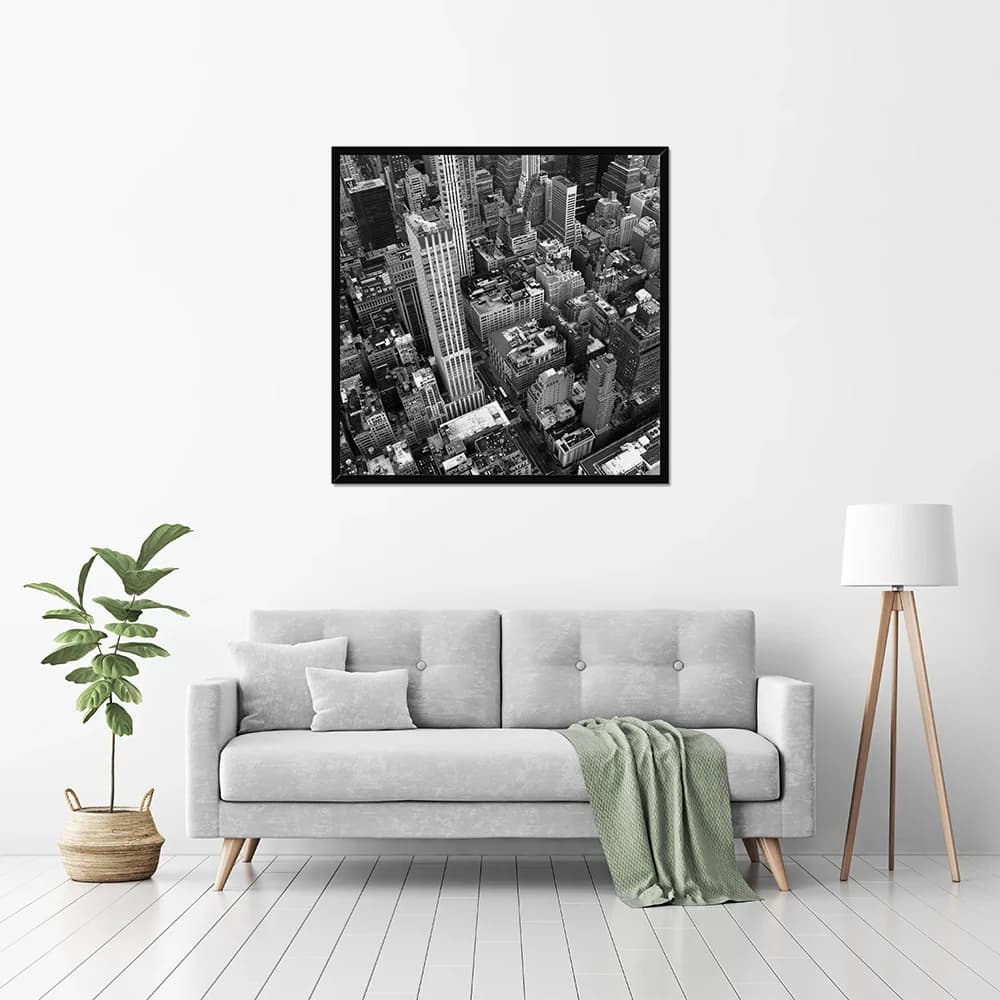 A black Classic Frame displayed above a sofa in a bright room
